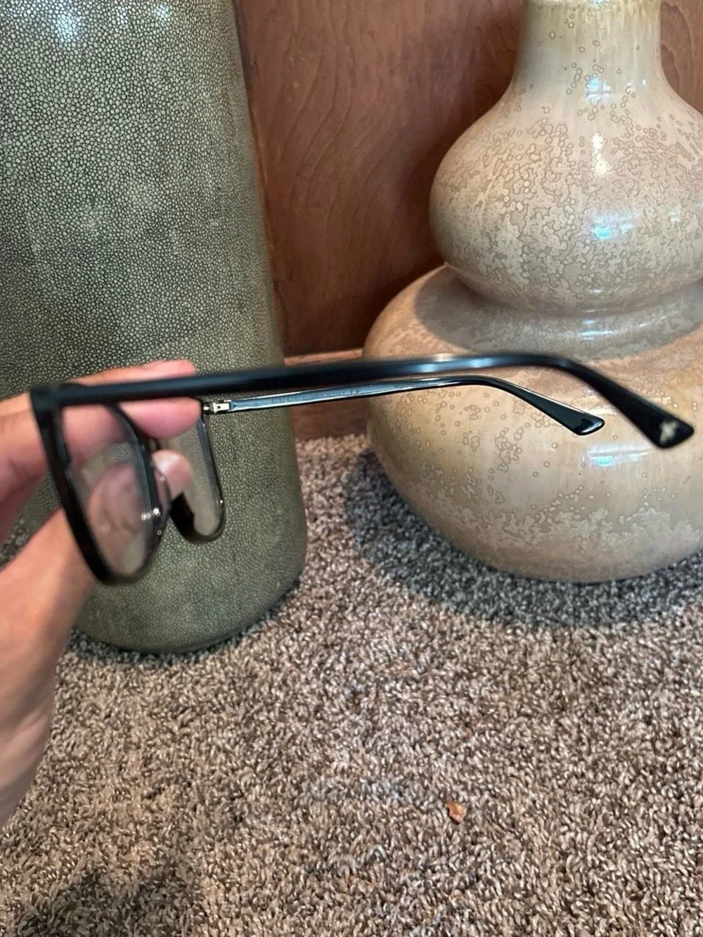 Gucci GG0026O eyeglasses in black with gold logo accents on the temples